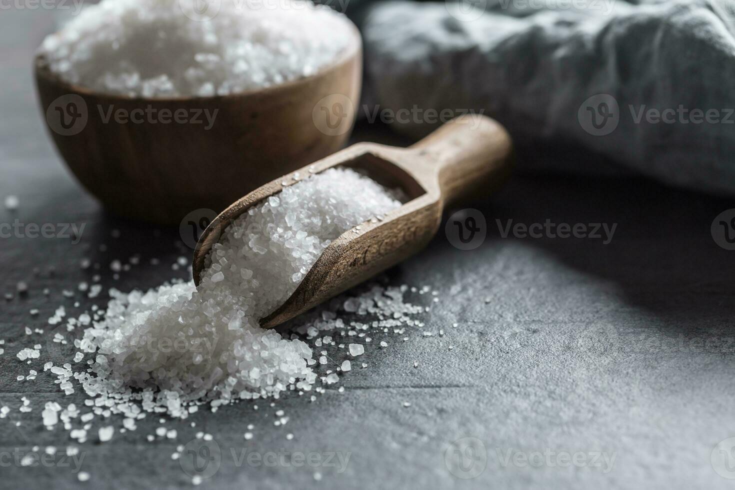 Crystaline sea salt in bowl and spoon - closeup photo