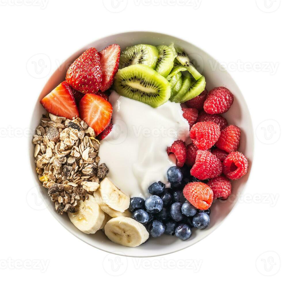 Top view of isolated fruit and yoghurt bowl with cereals, kiwi, strawberries, banana, blueberries and raspberries photo