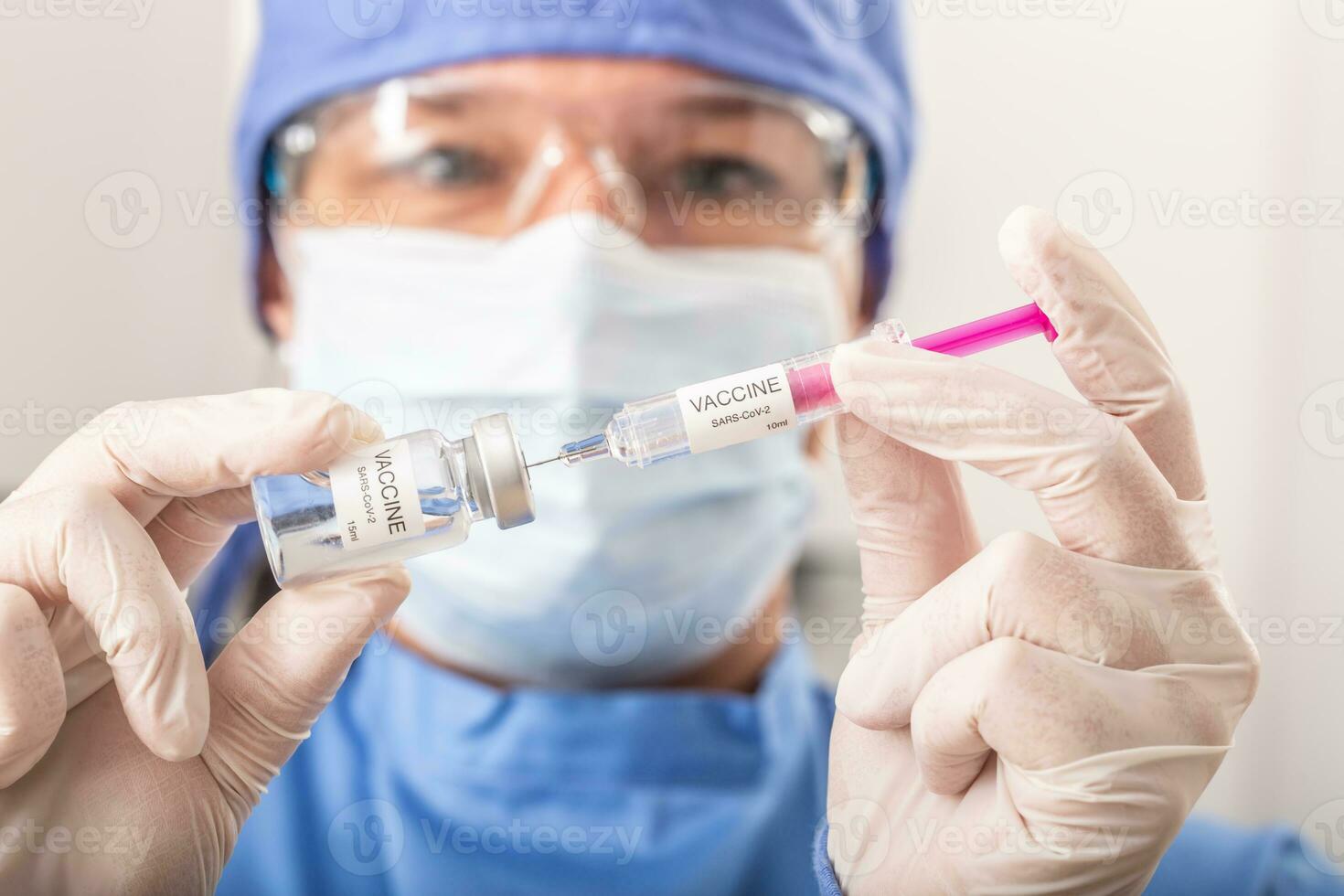 A medical worker putting SARS-CoV-2 vaccine against the coronavirus into an injection photo
