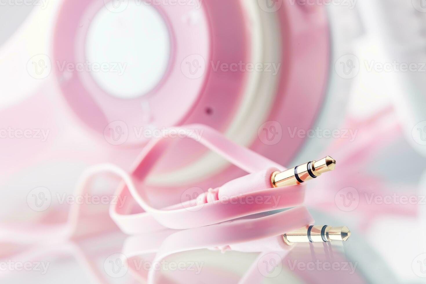 Headphones. Pink Headphones with jack connector - mirror reflection photo