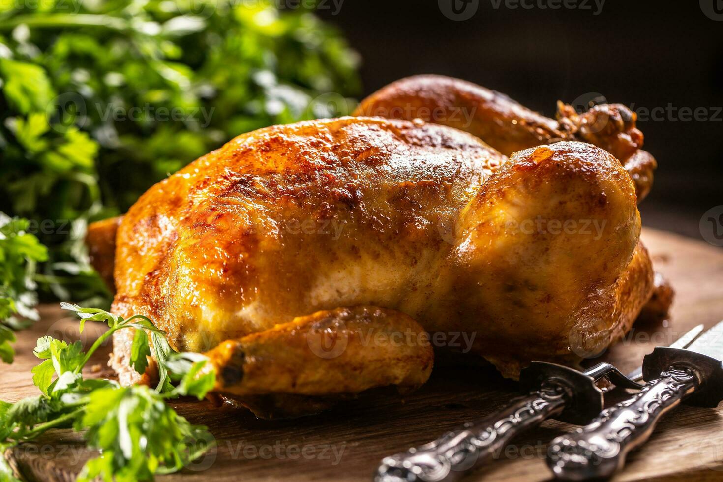 Roast chicken whole on a wooden cutting board photo
