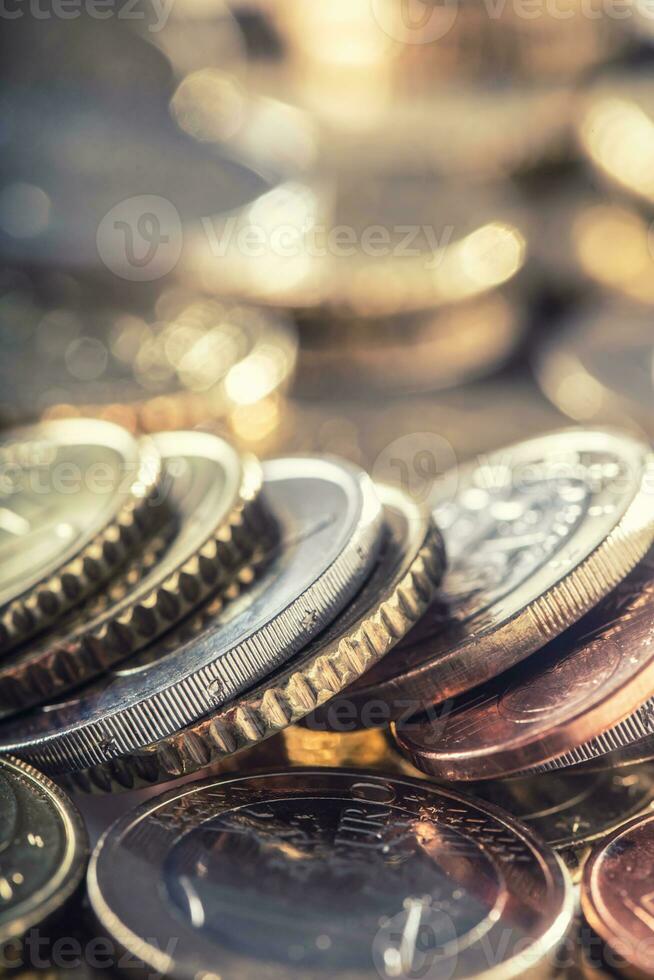 A pile of euro coins freely lying on the table. Close-up european money and currency photo