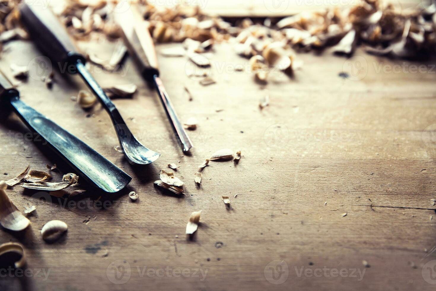 Woodworking vintage tools chisels with wood shawings on retro workbench photo