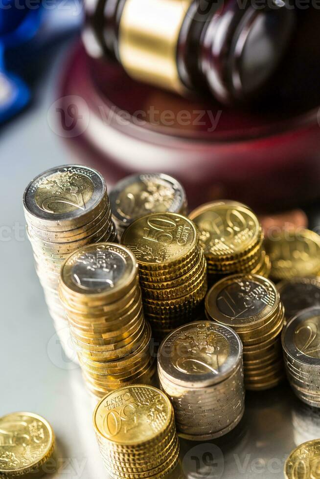 Towers with euro coins and justice hammer in the background photo