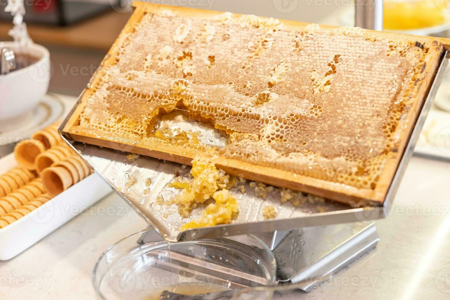 Honeycomb in a stainless steel box in a restaurant on a buffet table photo
