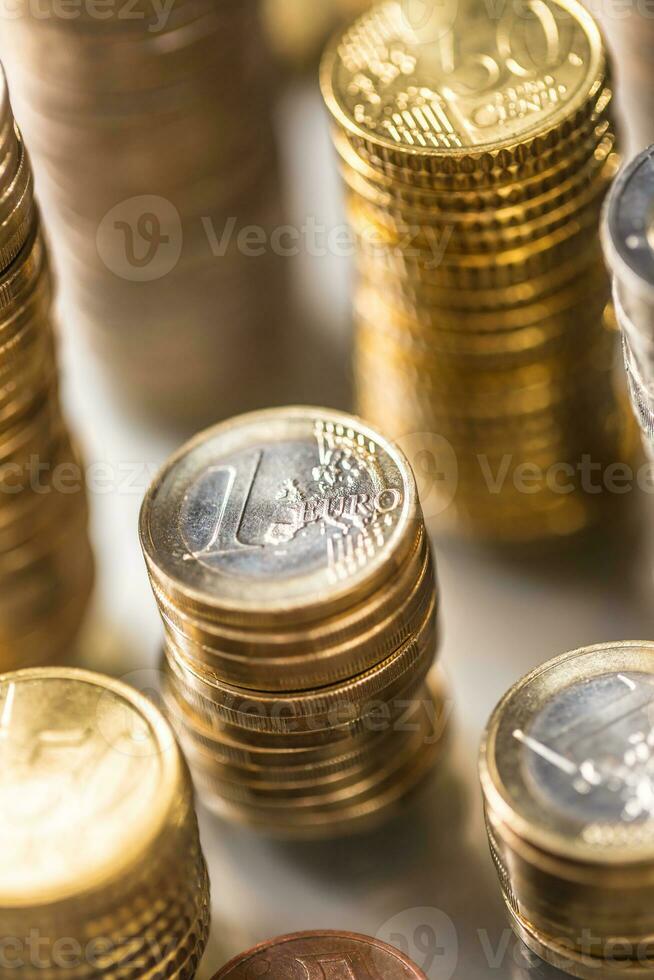 Towers of the euro coins stacked in different positions photo