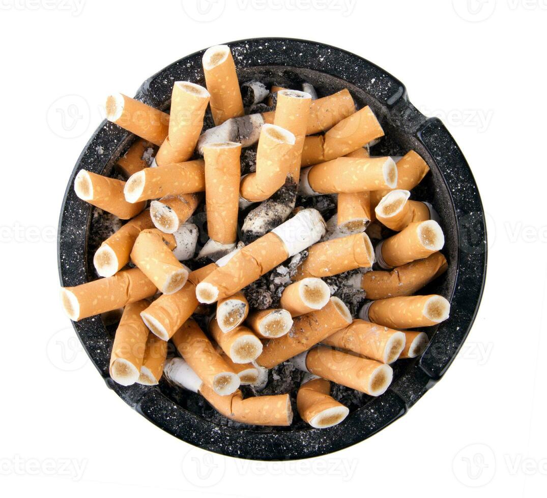 Isolated ciggarette ashtray full of butts and ash photo