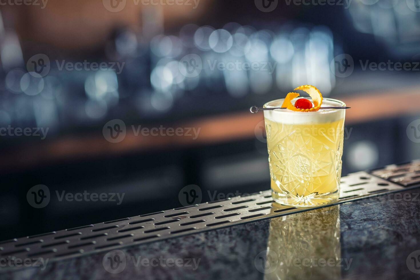 Cocktail drink whiskey sour at barcounter in night club or restaurant photo