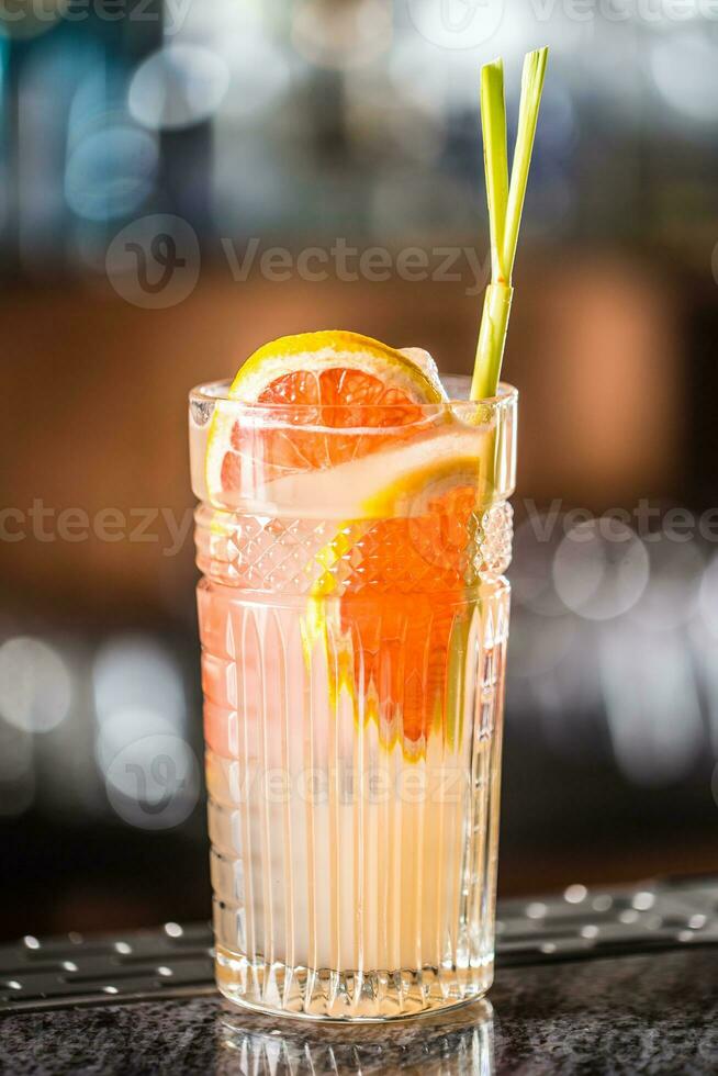 Paloma cocktail tequila drink with grapefruit at barcounter in night club or restaurant photo