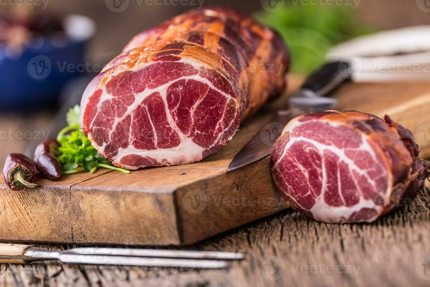 Pork meat.Pork chop smoked. Traditional smoked meat on oak wooden table in other positions photo