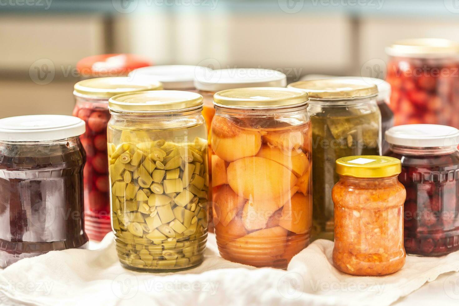 Homemade and homegrown fruit and vegetable preserves in jars photo