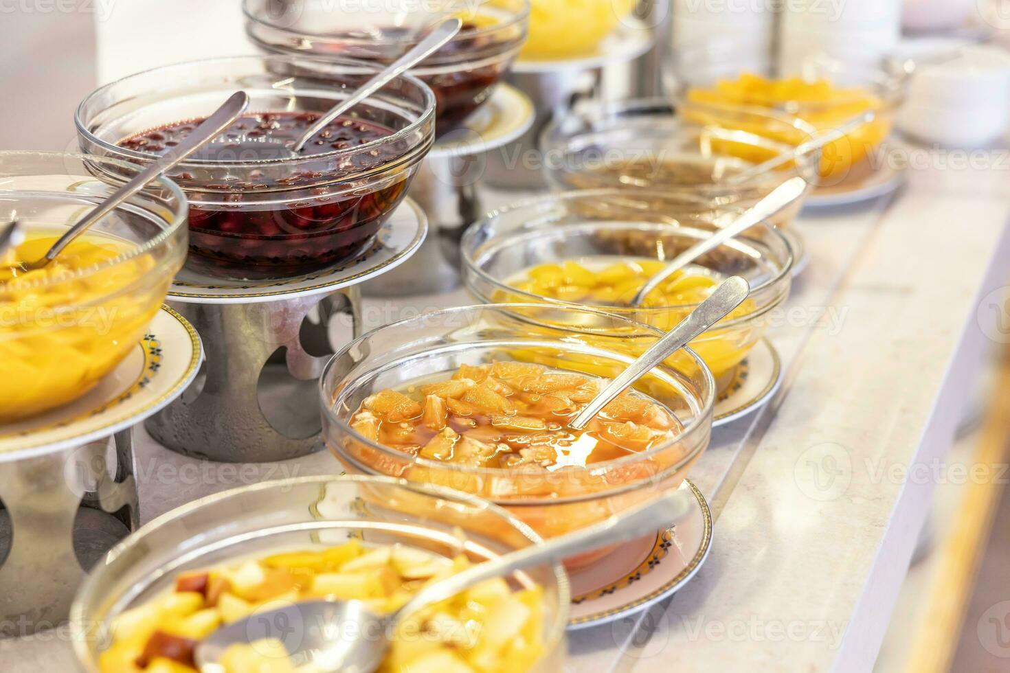 Fruit compotes in bowls on the buffet tables in the hotel restaurant photo