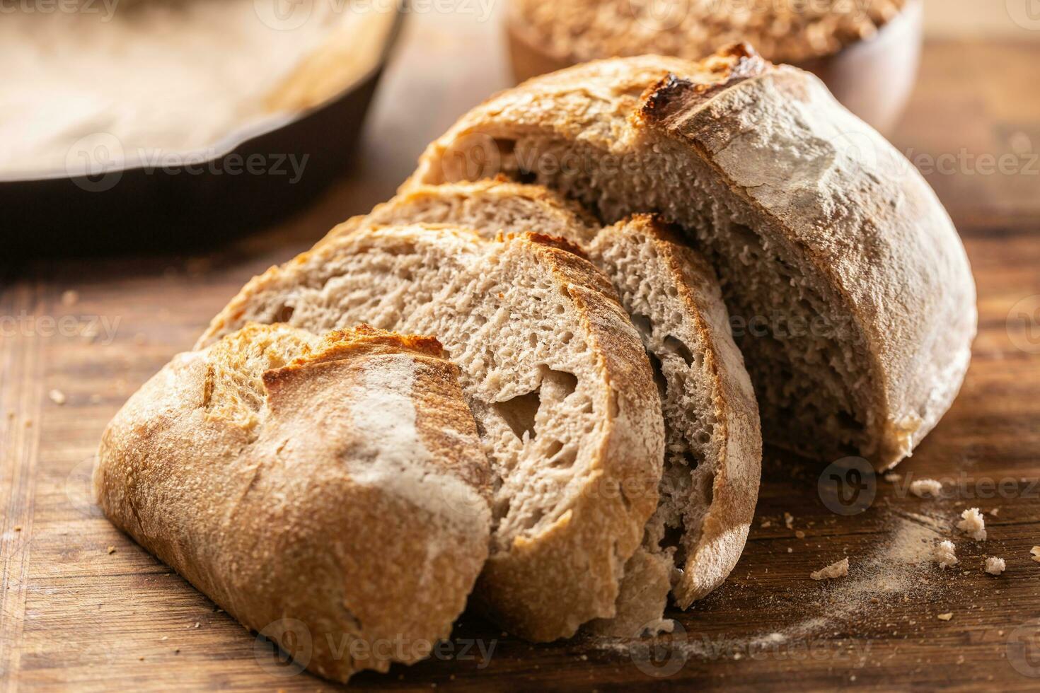 Savoury and crunchy slices of yeast bread with whole wheat grains in the background photo