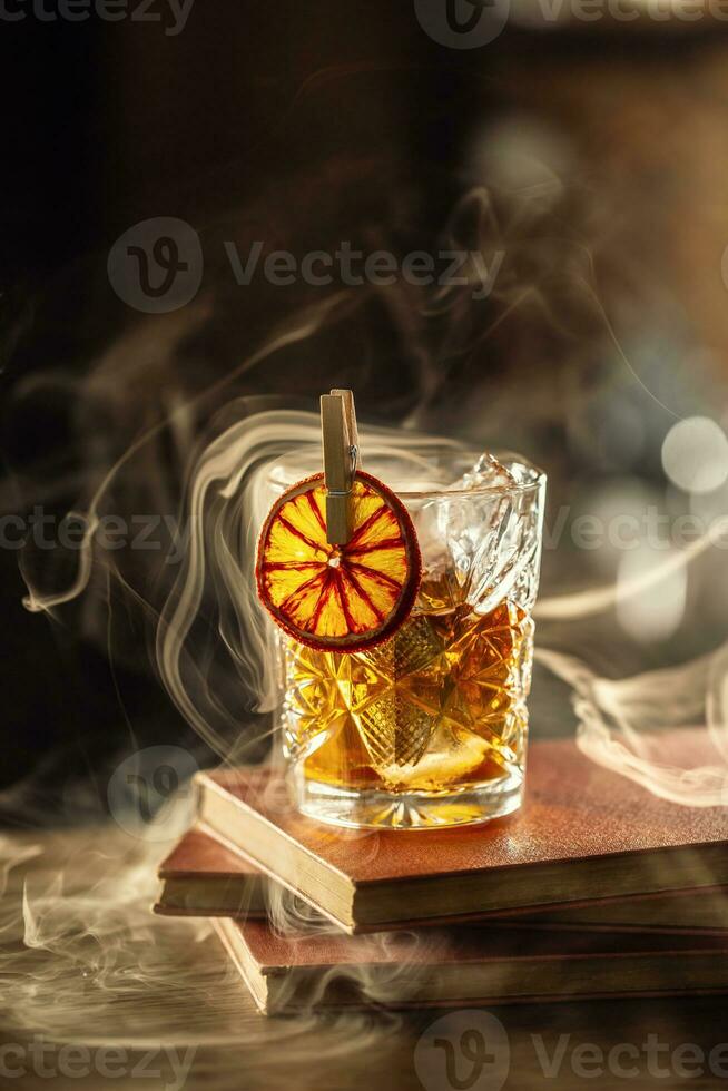 Glass cup with Old Fashioned cocktail in retro style photo