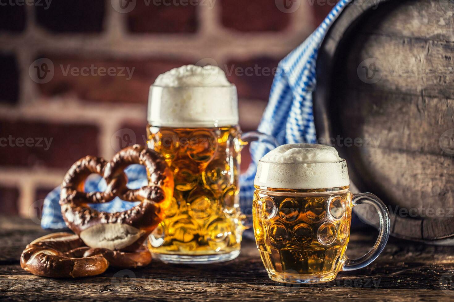 Oktoberfest large and small beer with pretzel wooden barrel and blue tablecloth photo