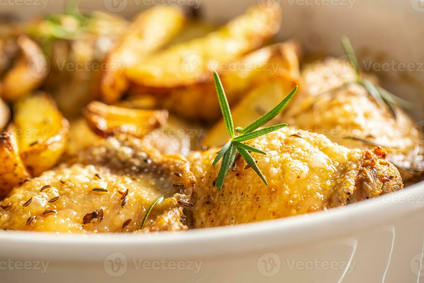 Chicken legs roasted with american potatoes in baking dish photo