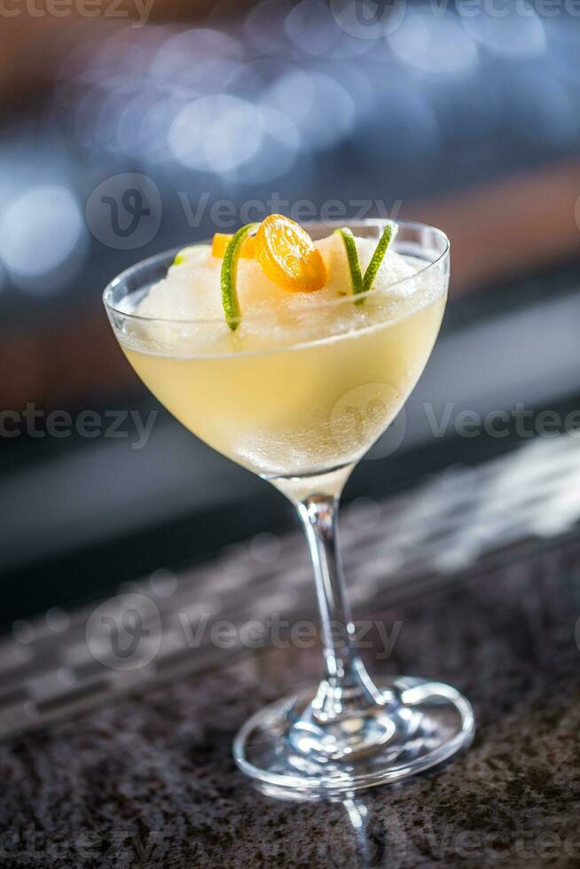 Cocktail drink frozen margarita at barcounter in night club or restaurant photo