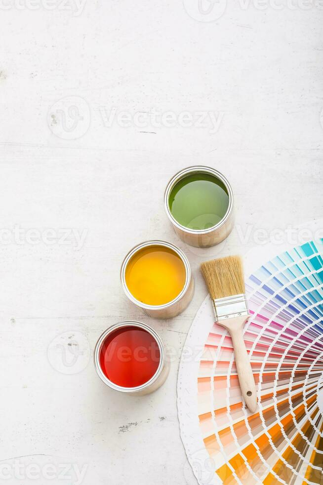 Paint cans color palette, cans opened with brushes on white board photo