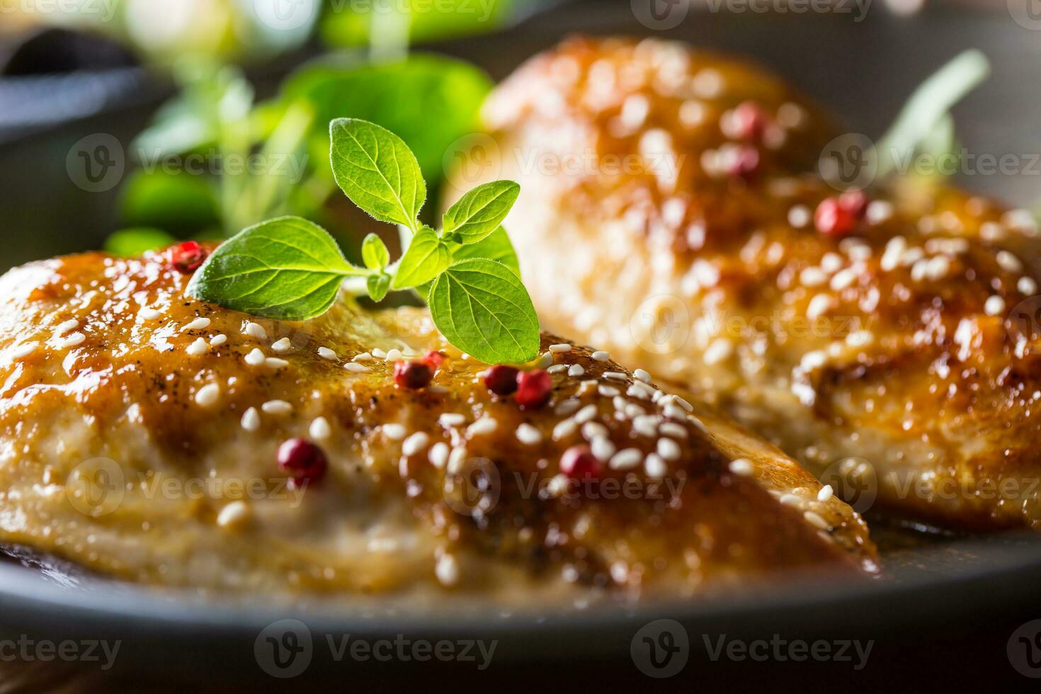 Roasted chicken breast sesame oregano and pepper in pan photo