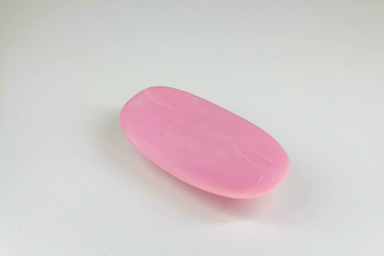 A piece of pink soap on a white background. Isolated. photo