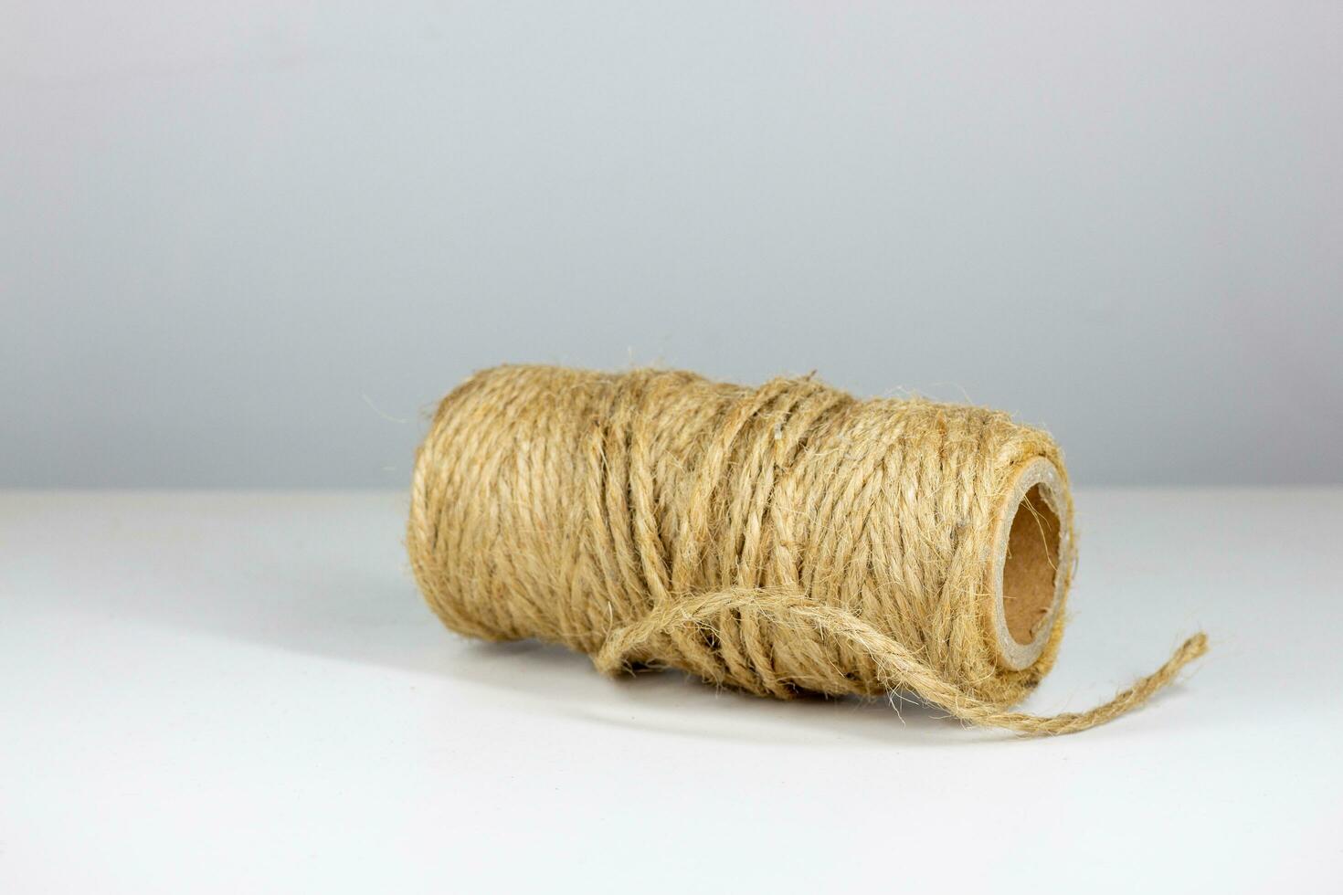 Roll of twine isolated on white background. Close up, selective focus. photo