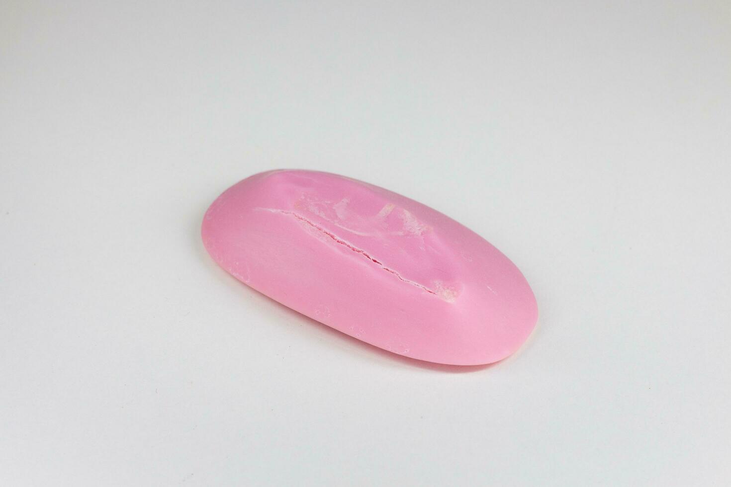 A piece of pink soap on a white background. Isolated. photo