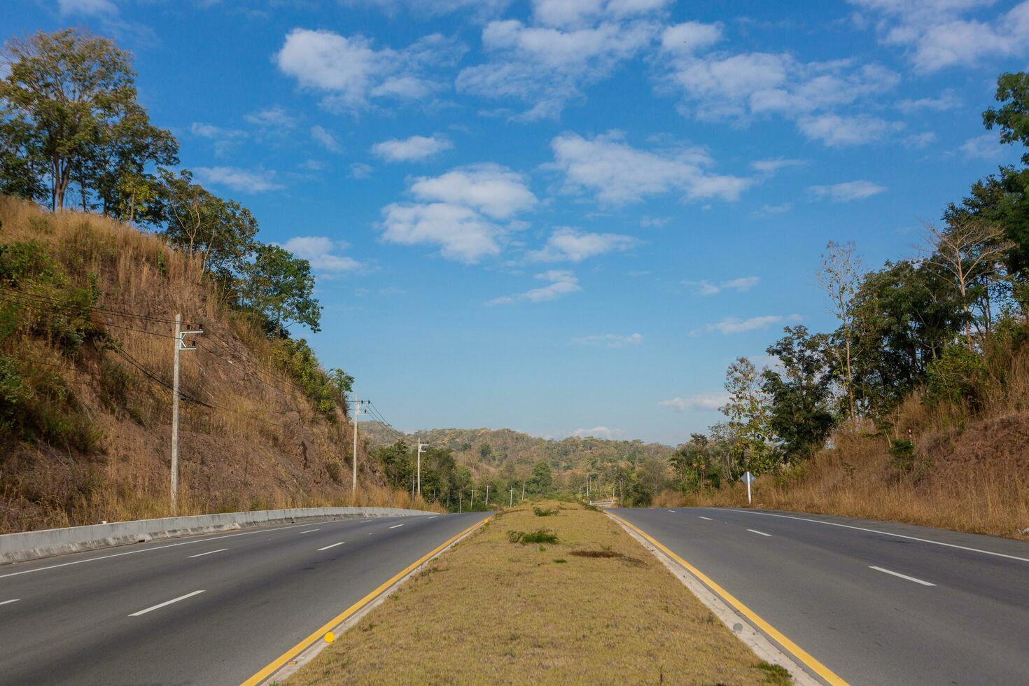 Road leading into the distance under blue sky photo