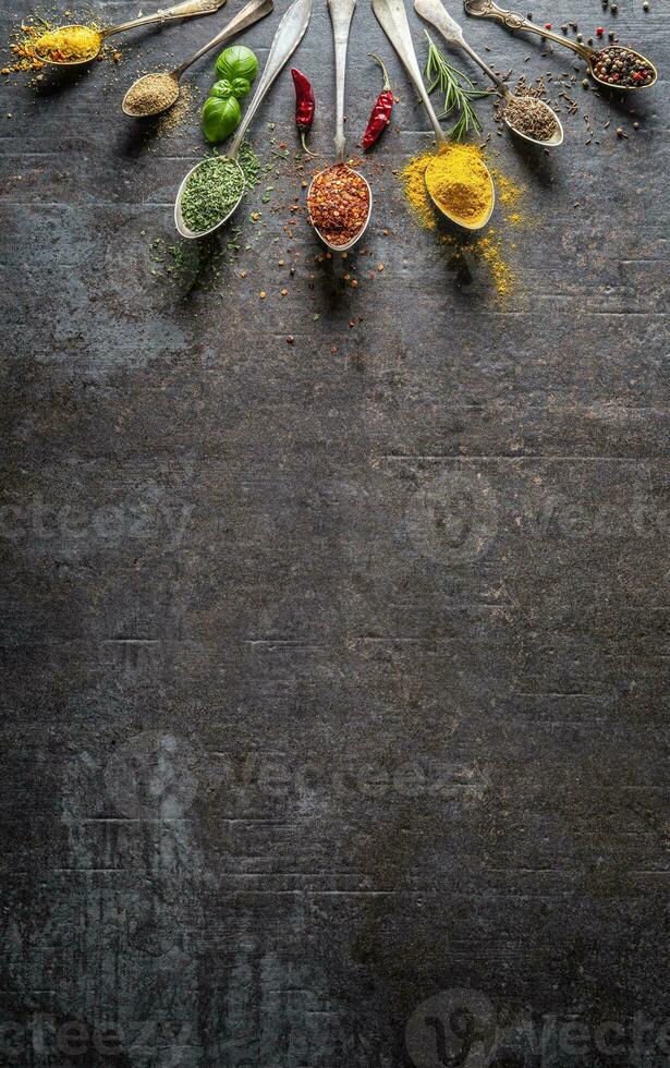 Spices and herbs for cooking on dark background - Top of view photo