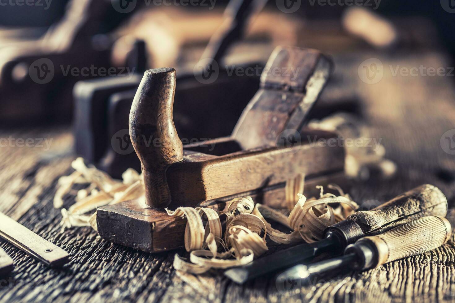 Old planer and other vintage carpenter tools in a carpentry workshop photo