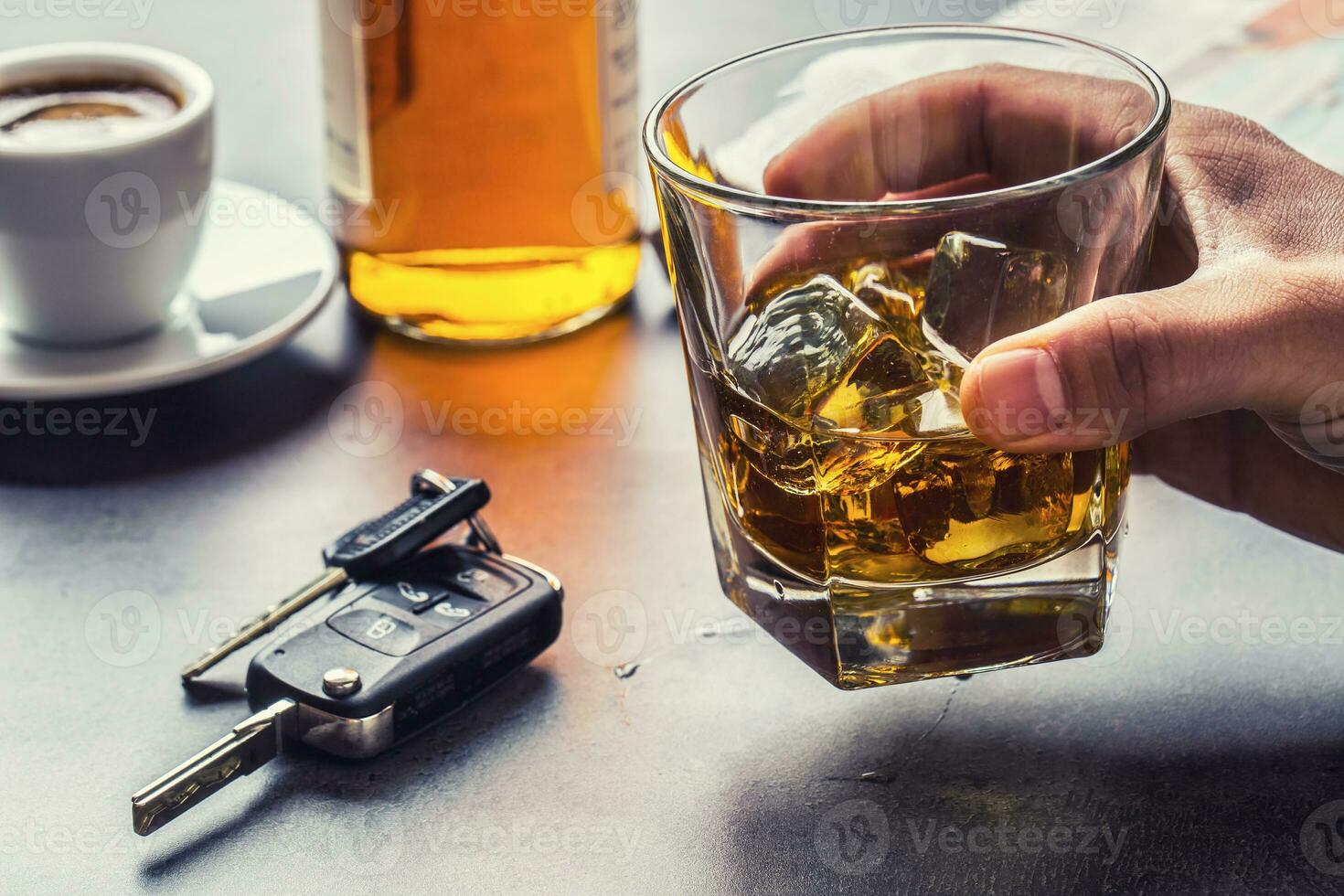 Glass of alcohol hand man the keys to the car and irresponsible driver photo