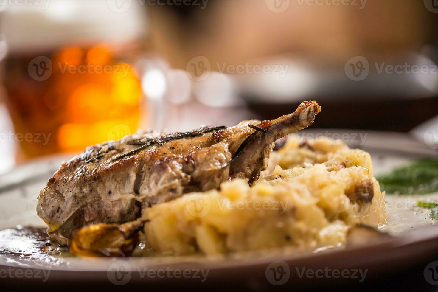 Iberian cutlet with mashes potatoes decoration and draft beere in pub or restaurant photo