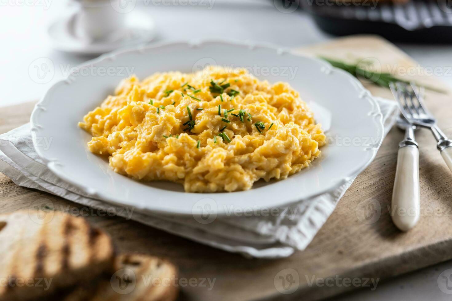 Appetizing breakfast full of proteins in a form of scrambled eggs in a plate photo