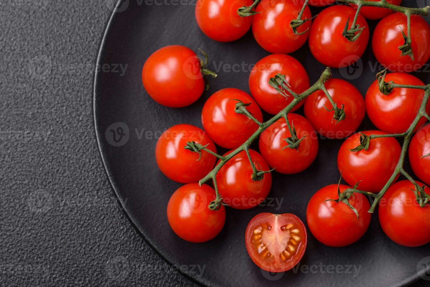 Delicious fresh cherry tomatoes on the branches as an ingredient for cooking a vegetarian dish photo