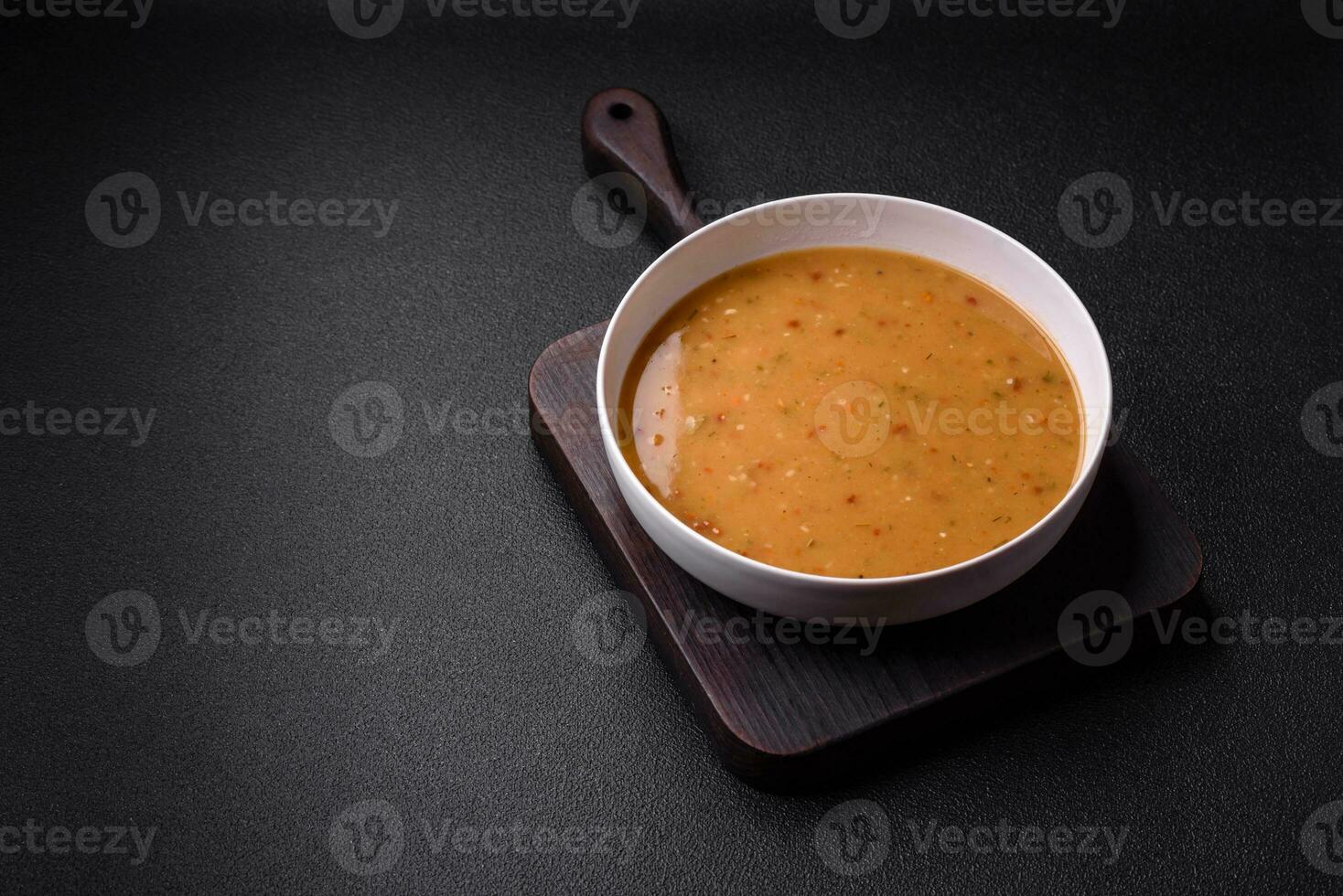 Delicious fresh vegetable soup with carrots, peppers, potatoes and onions photo