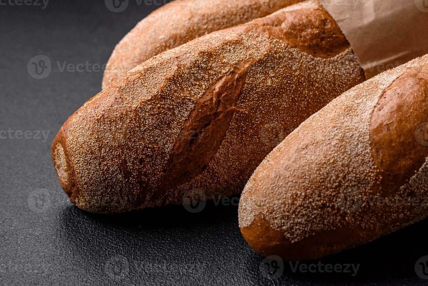 French baguette bread on a dark textured concrete background photo