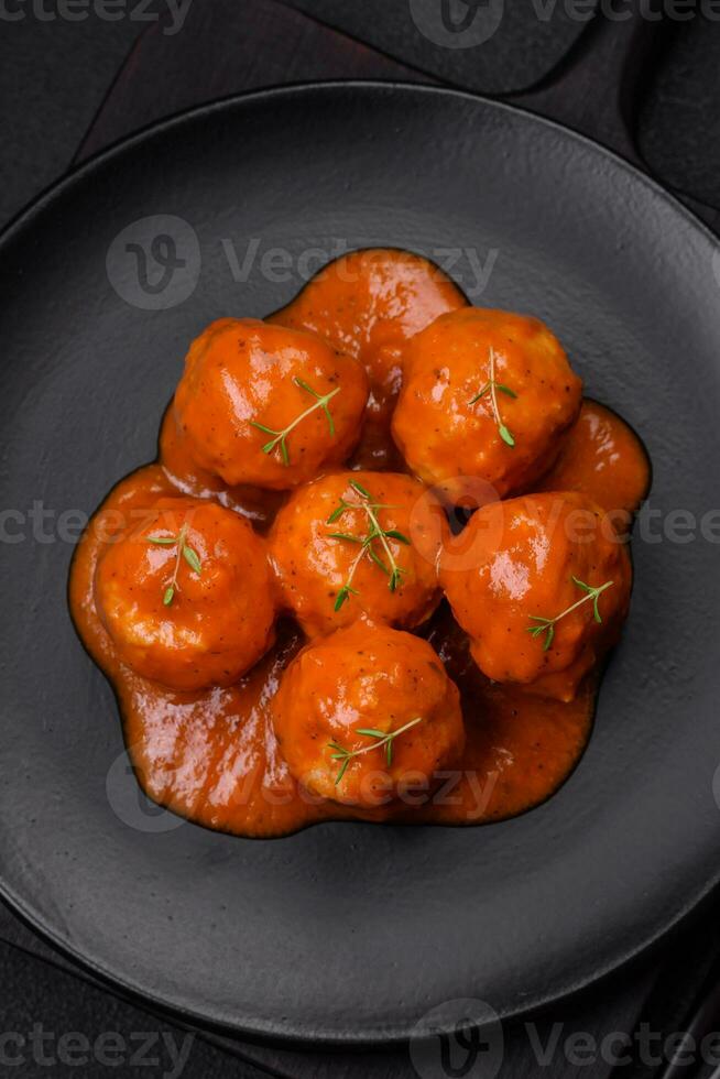 Delicious fresh meatballs in tomato sauce with salt, spices and herbs photo