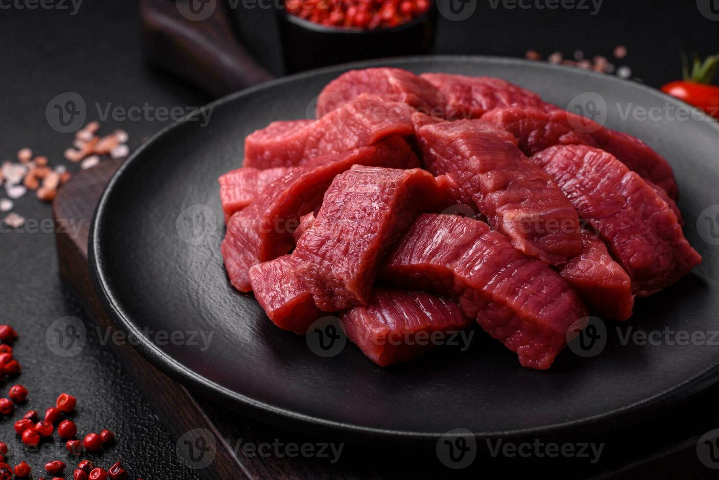 Juicy fresh raw beef meat with salt, spices and herbs photo
