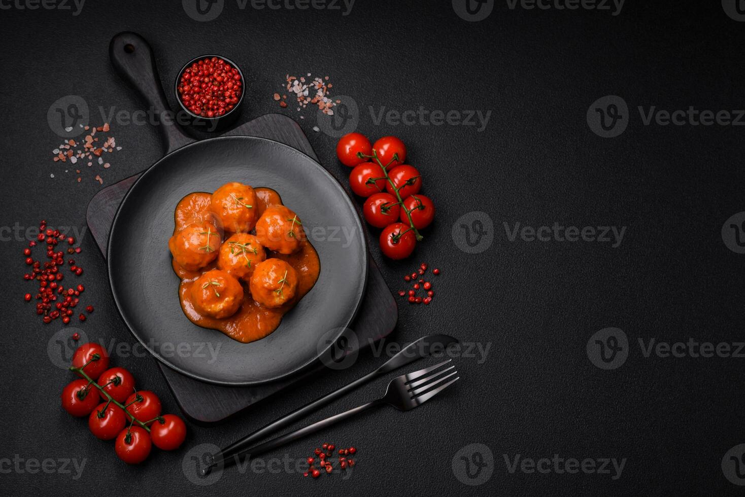 Delicious fresh meatballs in tomato sauce with salt, spices and herbs photo