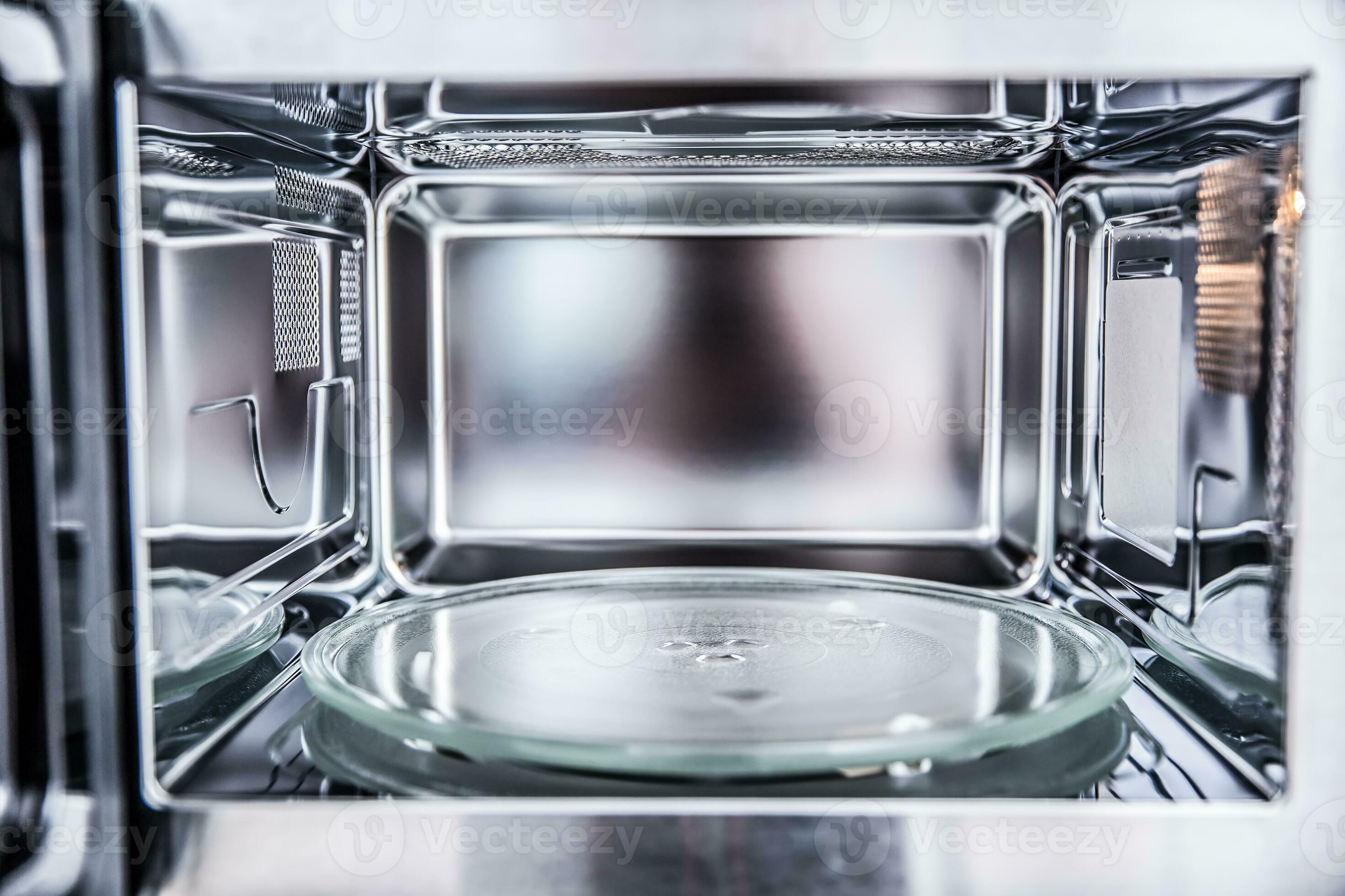 Inside view of new clean staniless, empty microwave oven. 27487155