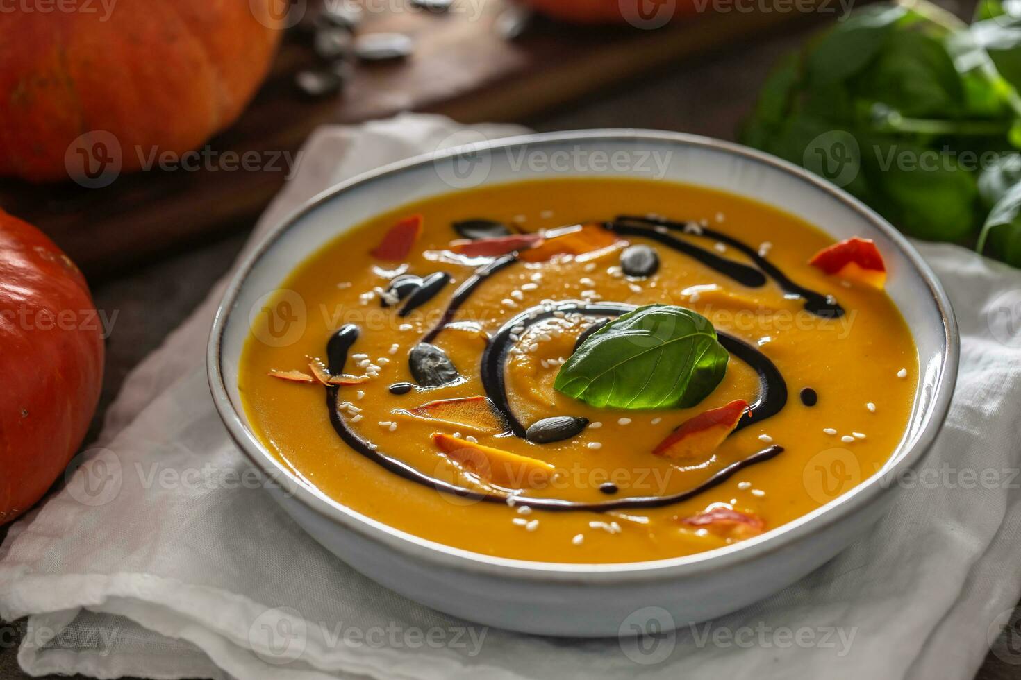 Homemade pumpkin soup in bowles with. Autumn hokkaido soup with balsamic vinegar photo