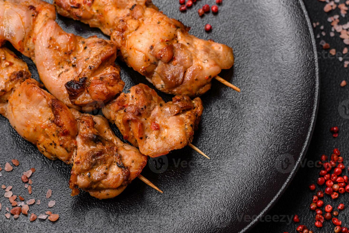Delicious fresh, juicy chicken or pork kebab on skewers with salt and spices photo