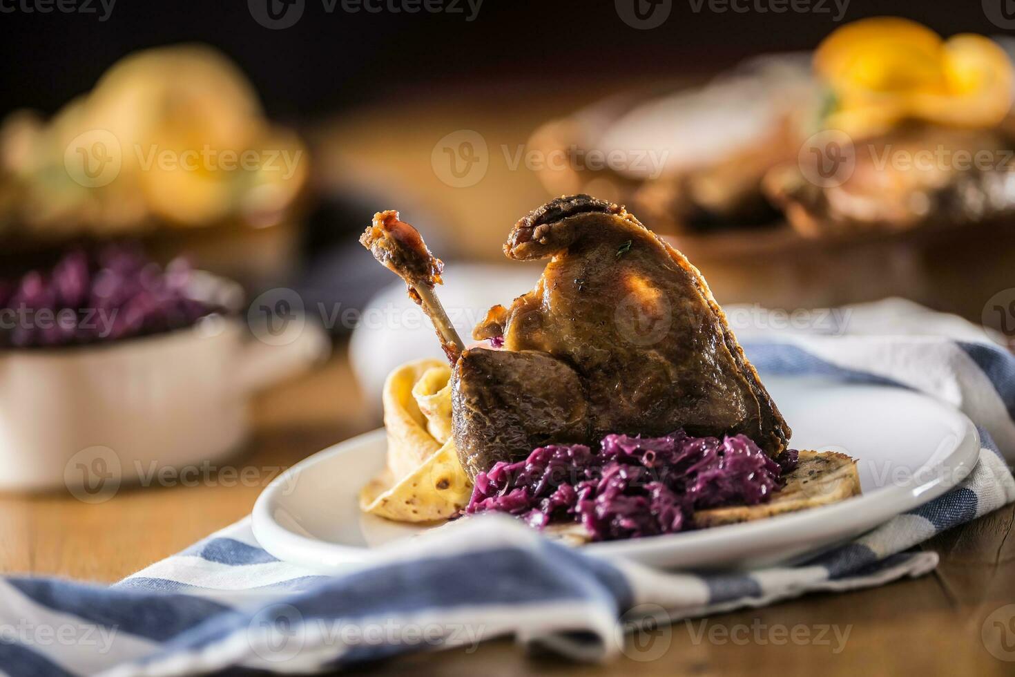 Roasted christmas duck leg red cabbage dumplings liver draft beer and baked buns photo