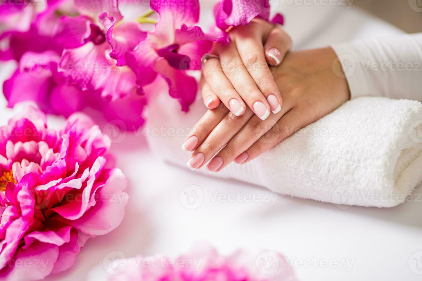 Closeup shot of beautiful female dands with nails of france manicure. Manicure and spa concept photo
