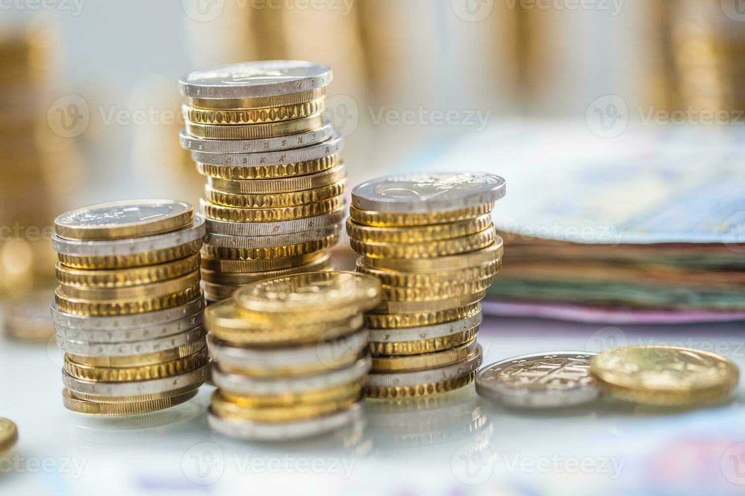 Euro banknotes and coins togetger on white table - close-up photo