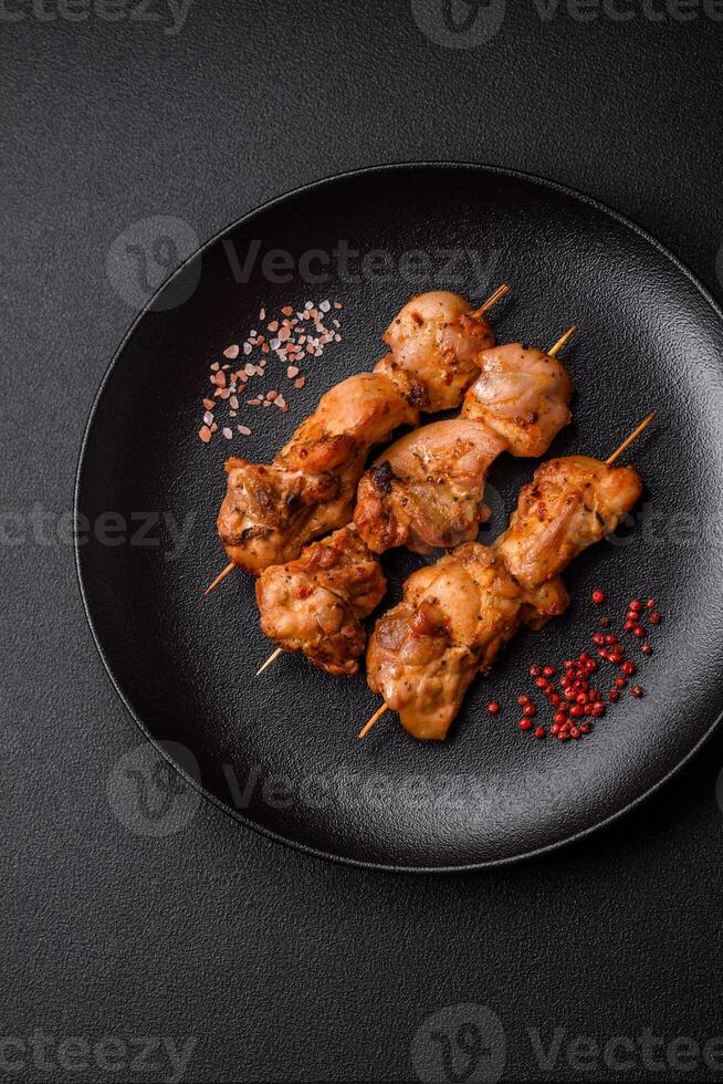 Delicious fresh, juicy chicken or pork kebab on skewers with salt and spices photo