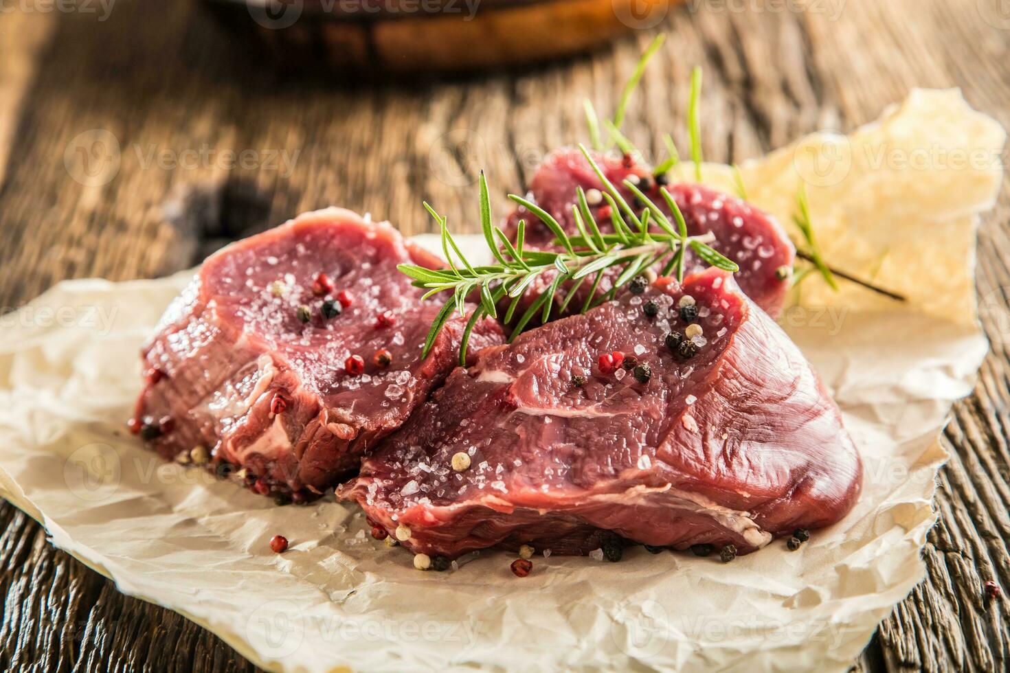 Close-up slices of beef tenterloin steak salt pepper and rosemary photo