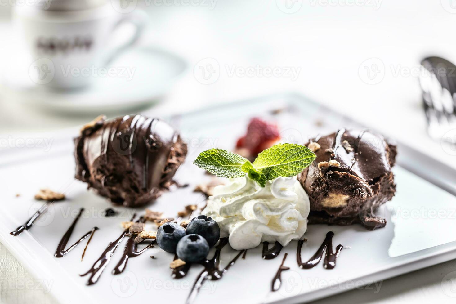 Sweet chocolate balls dessert with whipped cream, blueberries and mint photo