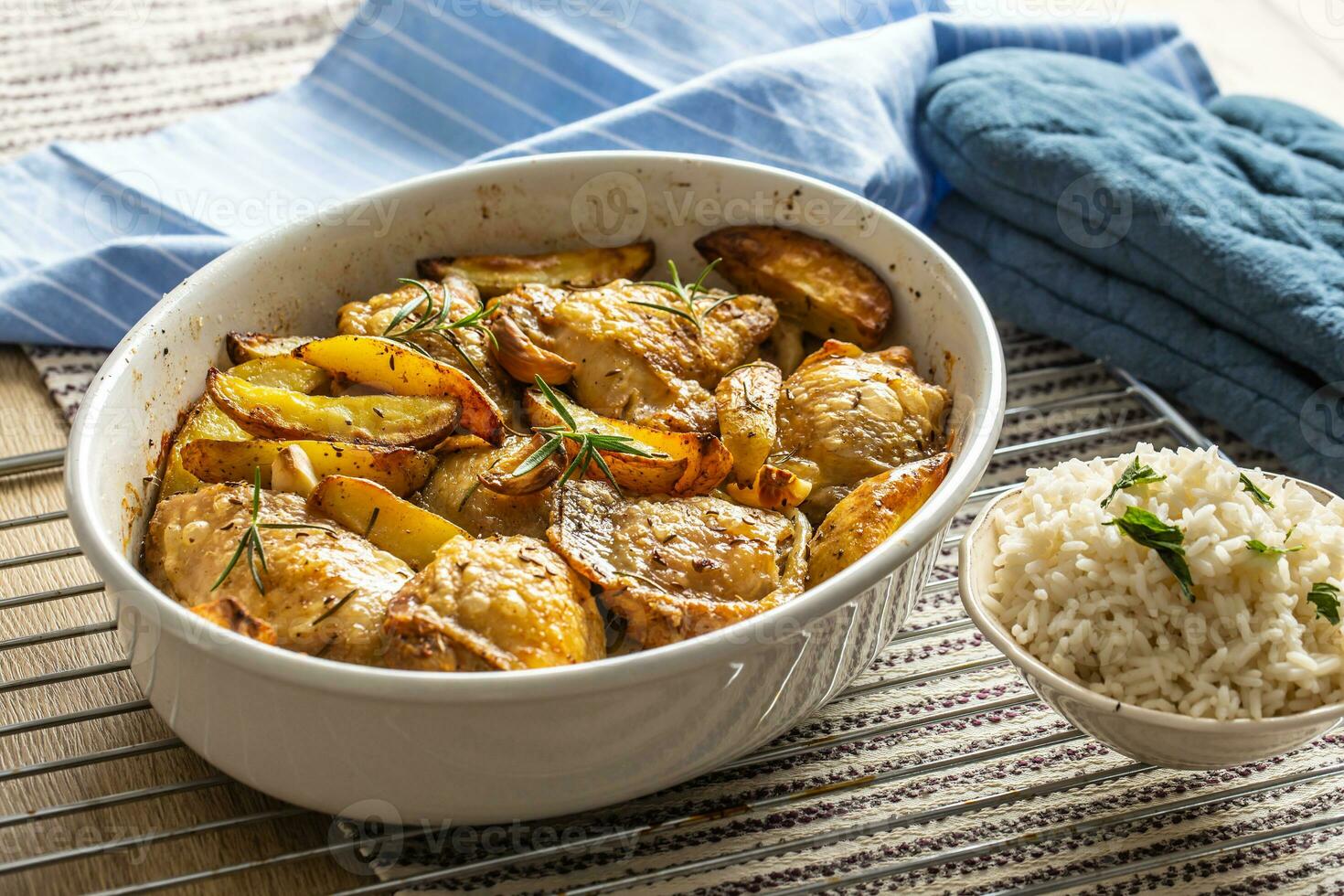 Chicken legs roasted with american potatoes in baking dish photo