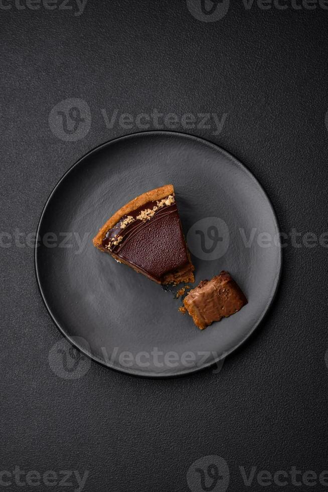 Delicious, fresh, sweet chocolate cake with nuts cut into slices photo