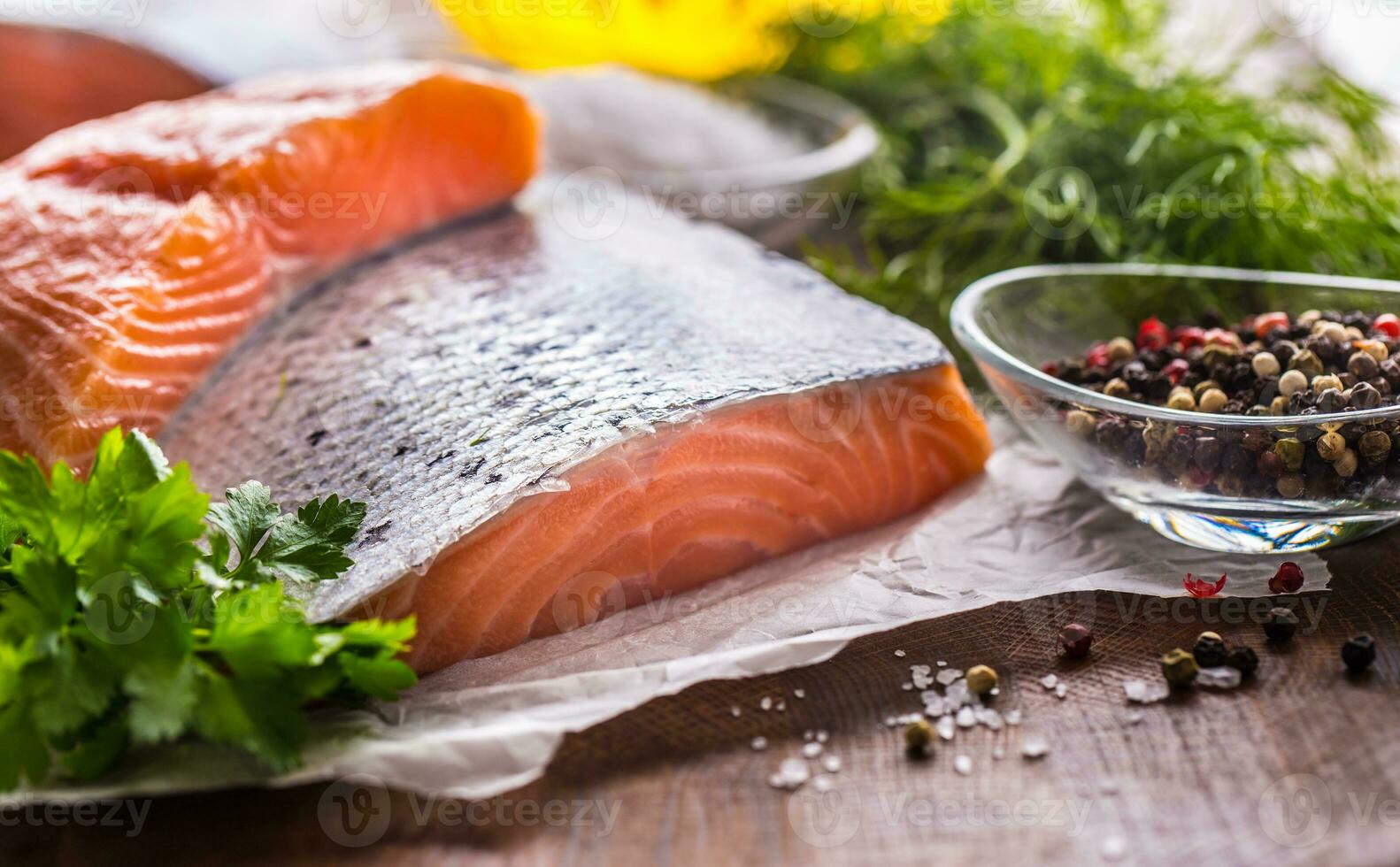 Raw salmon fillet with dill lemon olive oil salt and pepper photo